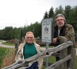 Two landowners pose with a stewardship sign