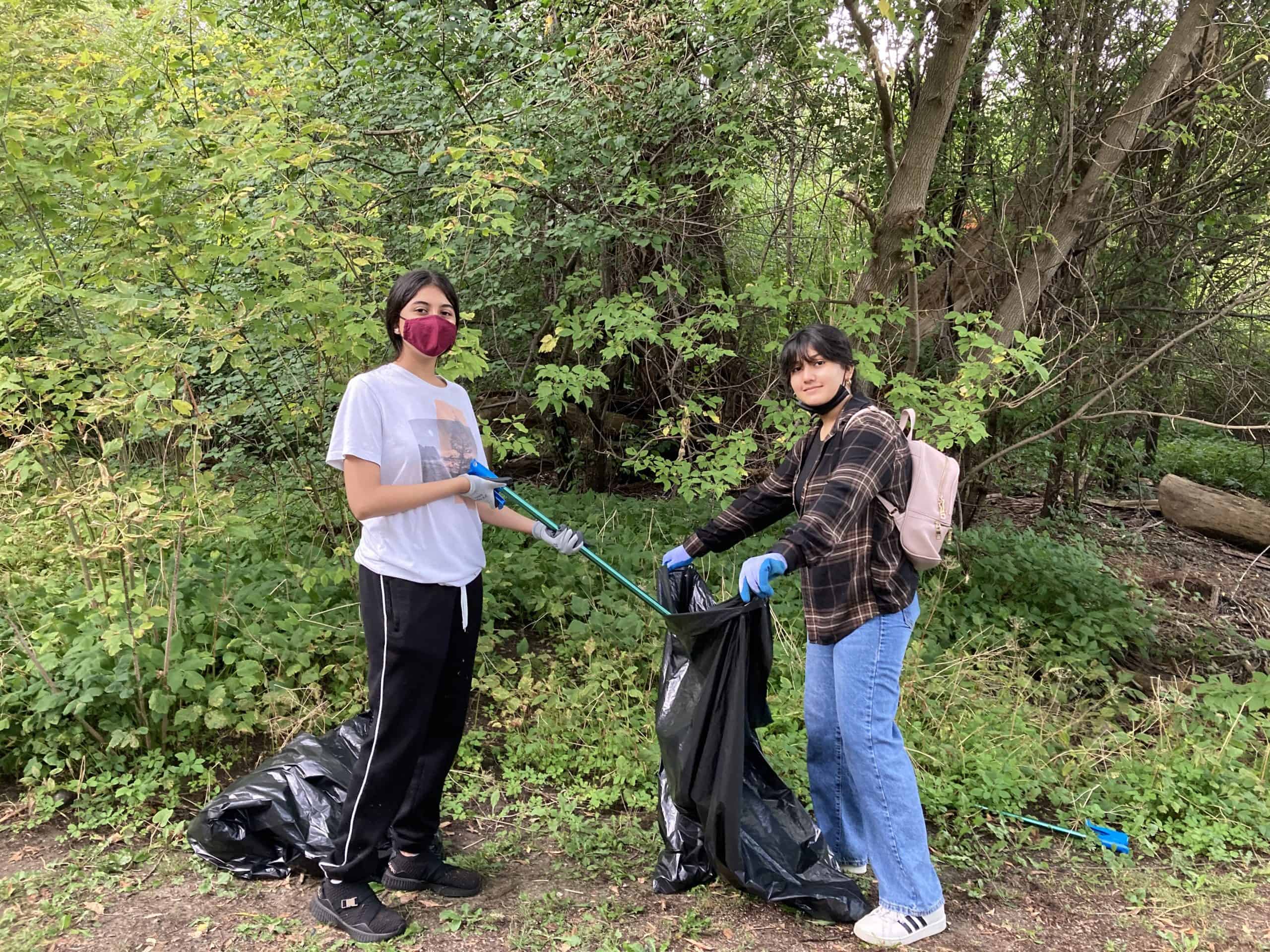 Two people collecting garbage